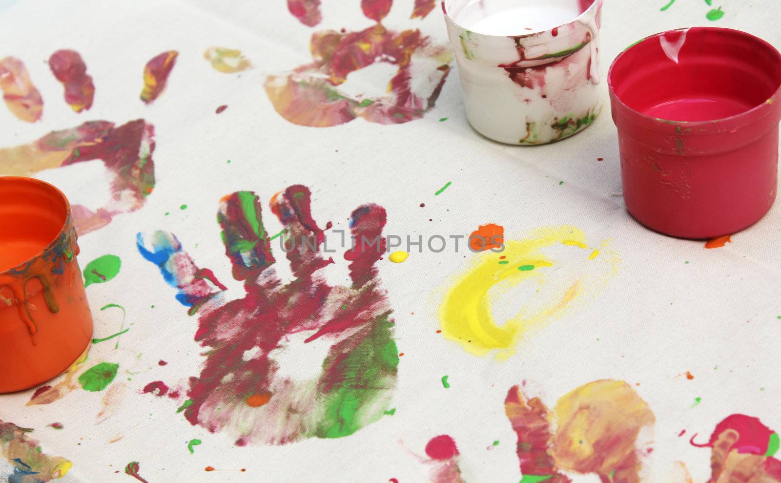 hand print and tubs of paint on canvas