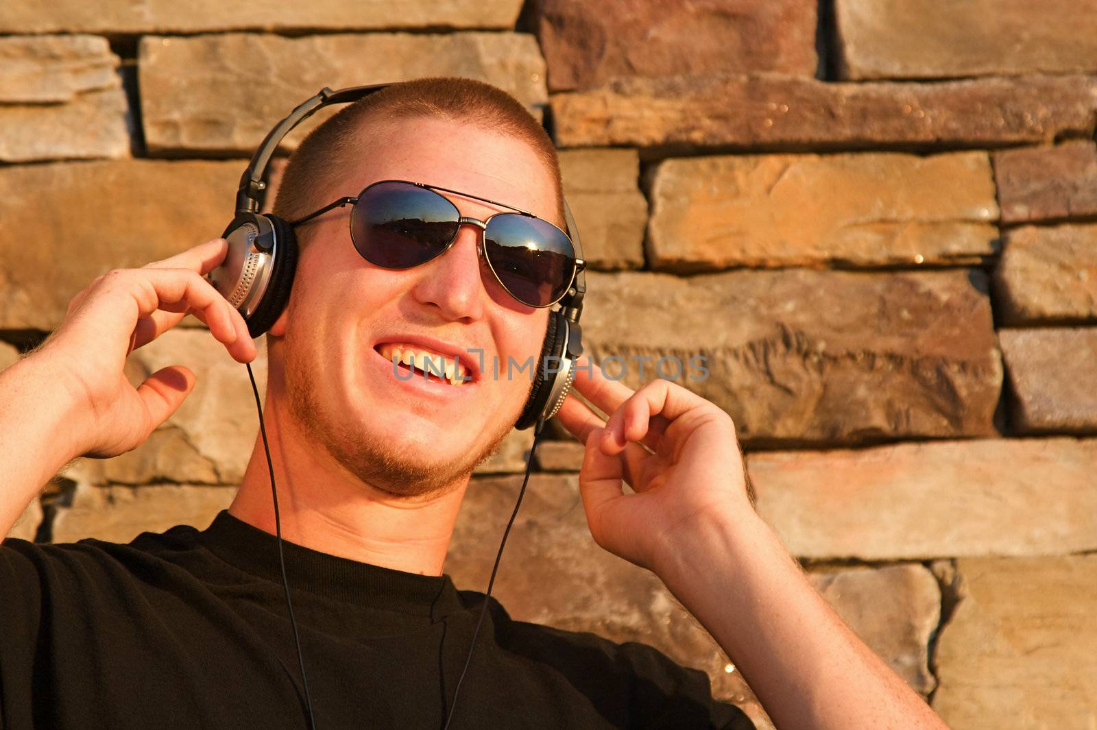 A cool young man listens to music on some headphones