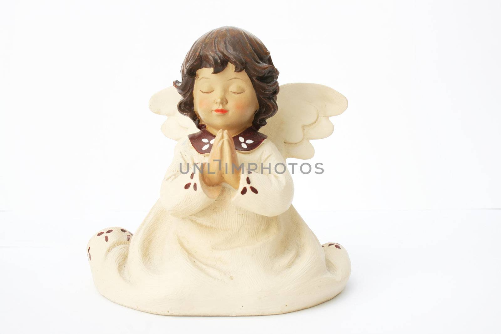 a ceramic angel praying isolated on white
