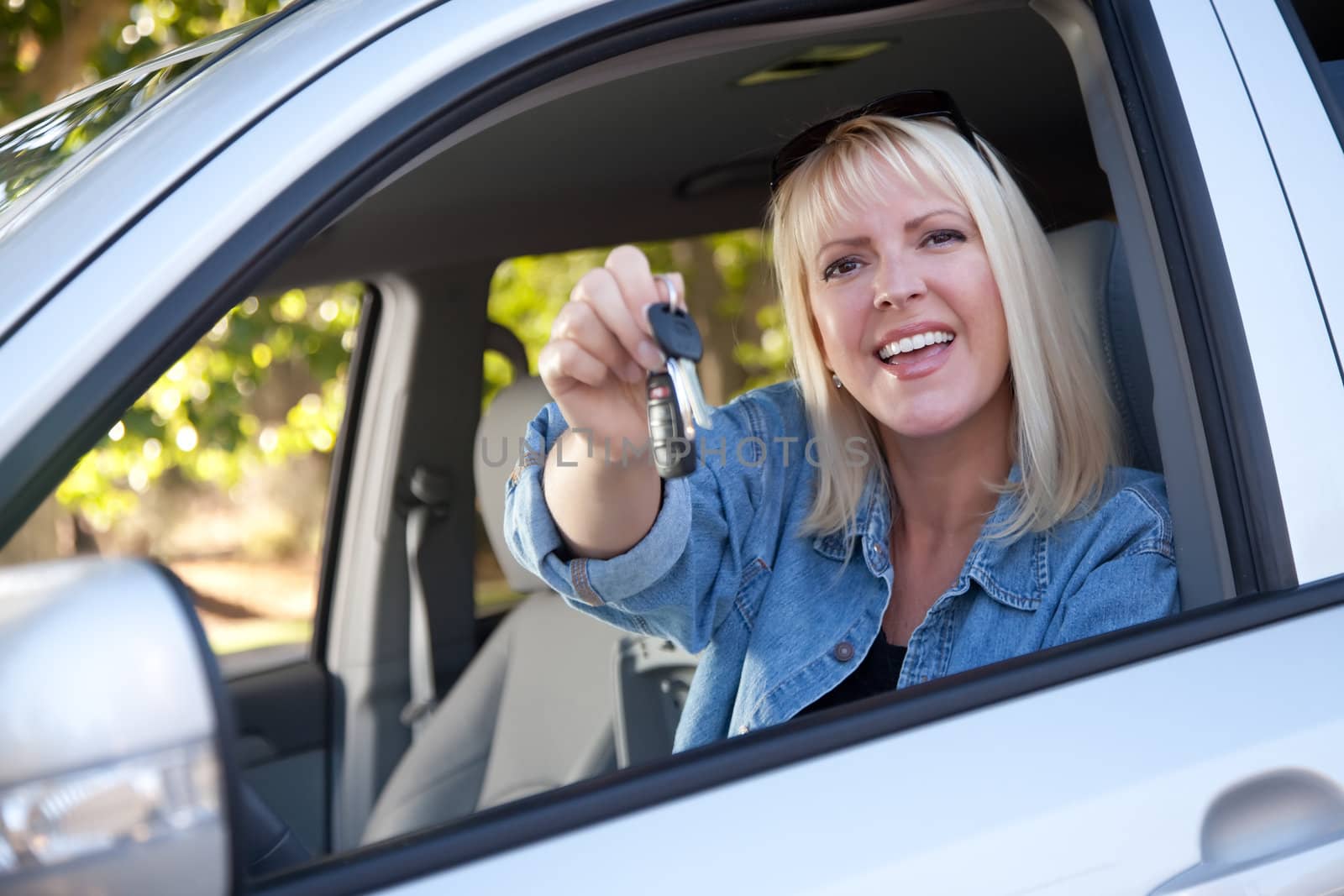 Attractive Happy Woman In New Car with Keys.