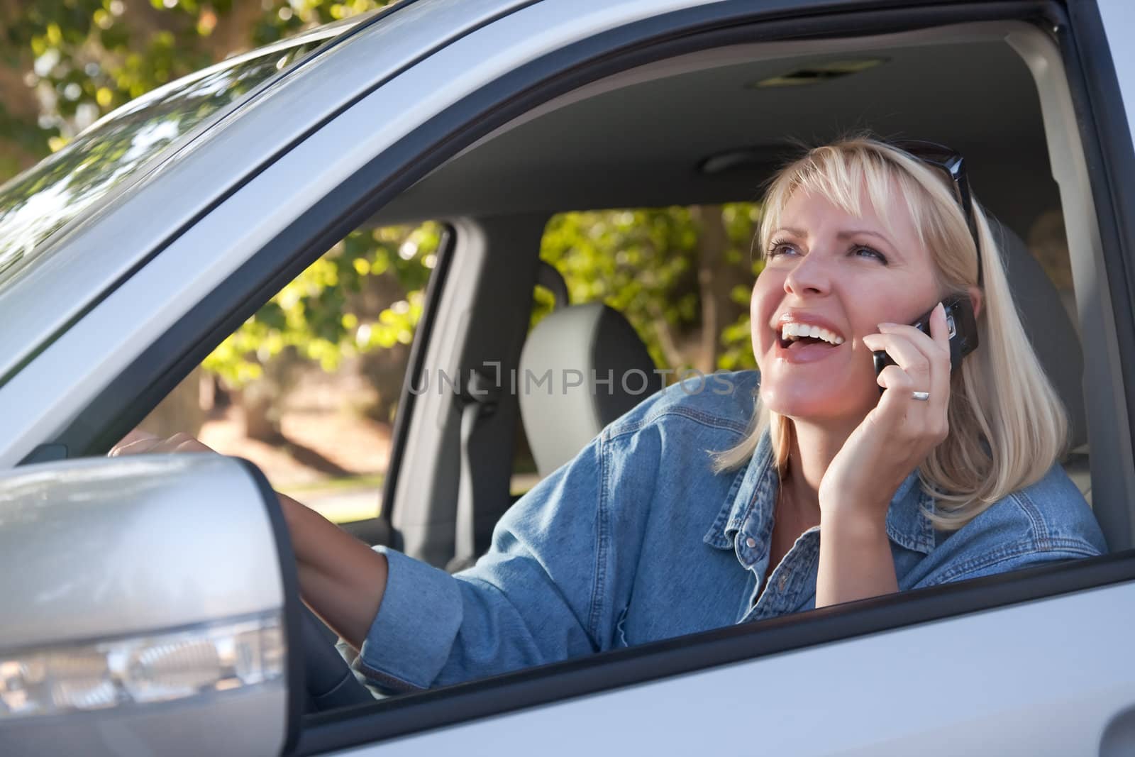 Attractive Woman Using Cell Phone While Driving by Feverpitched