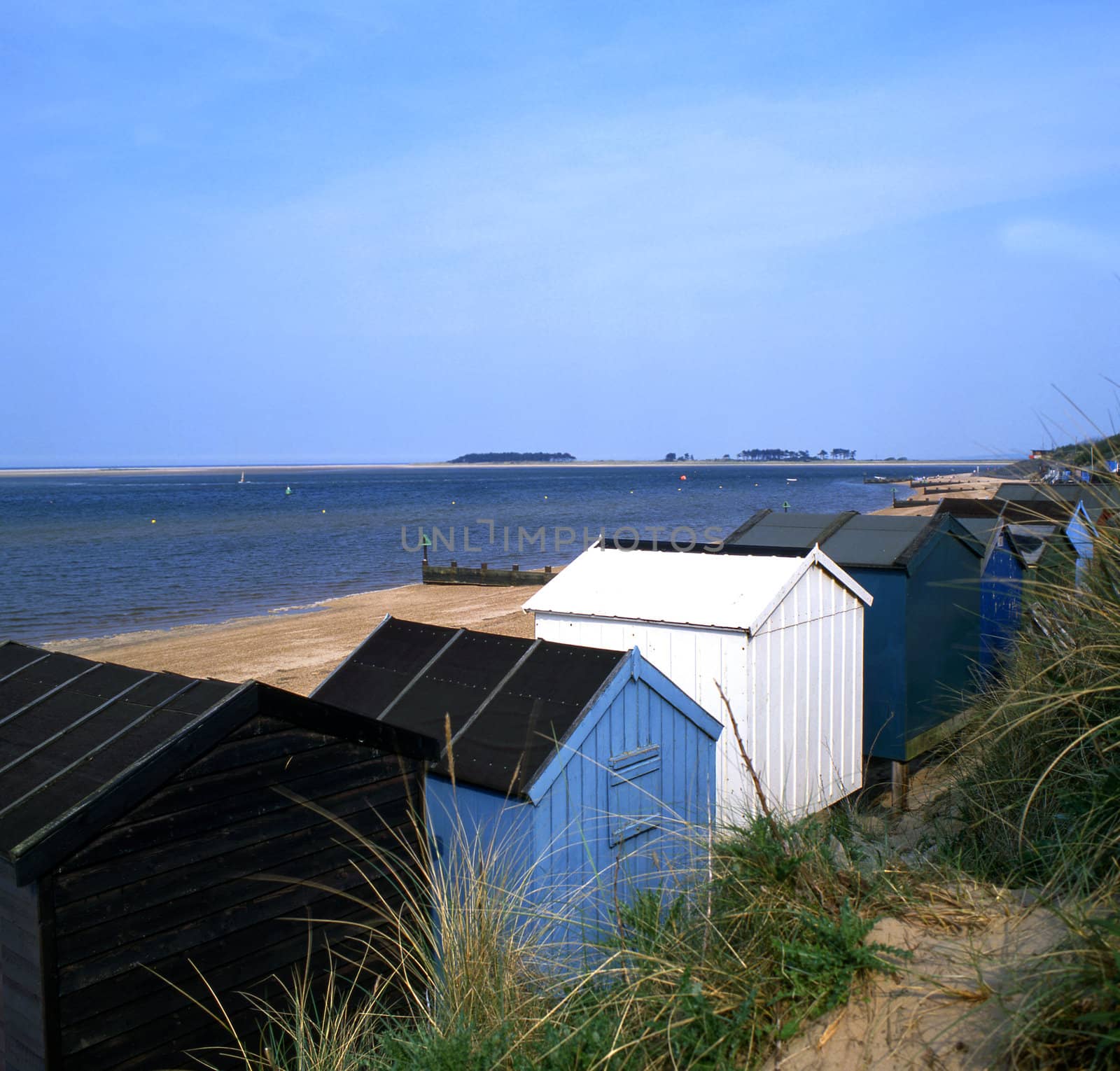 Several beach huts by the sea