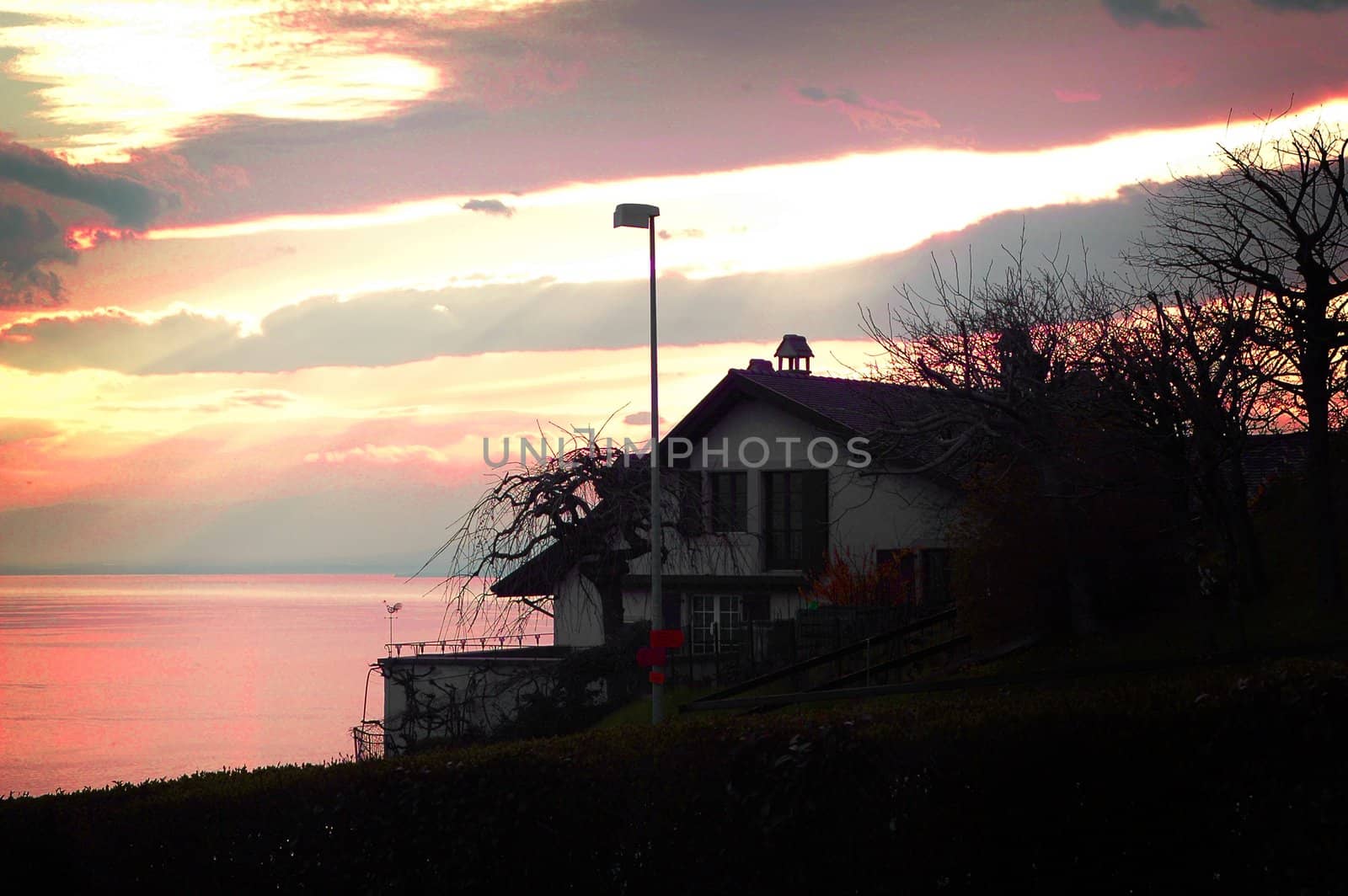 Sunset on lake Geneva behind a restaurant outside Lausanne, Switzerland.