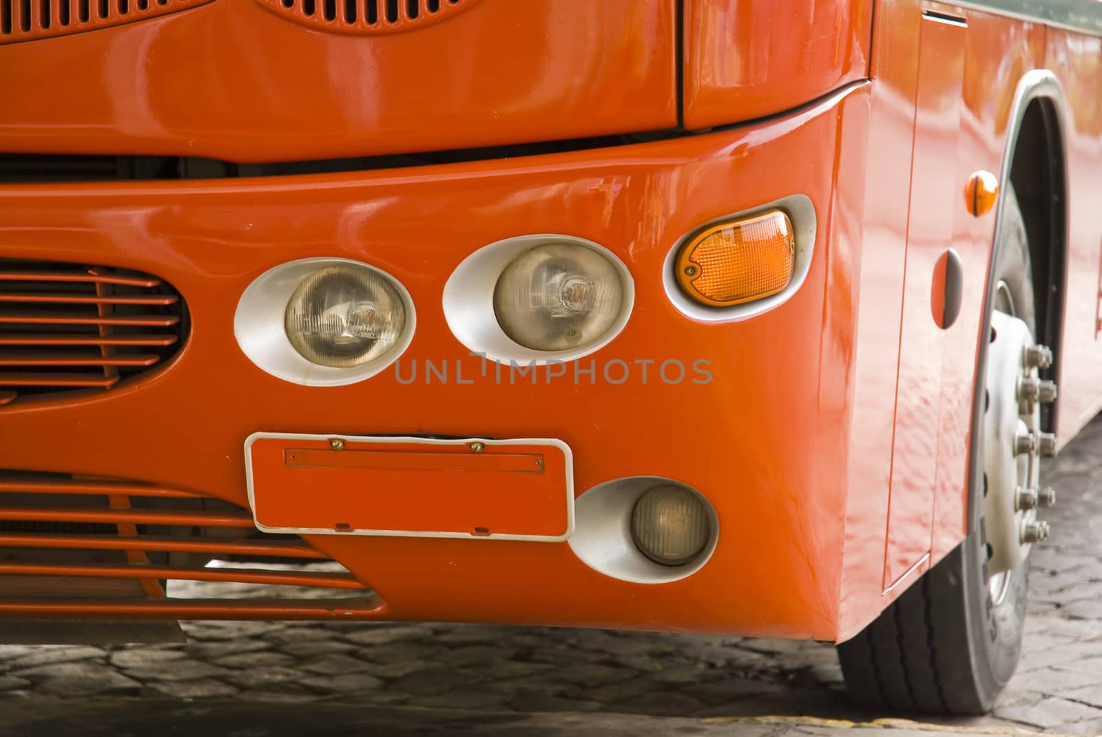 Detail shot of a red us, with empty license plate. Perpendicular shot.