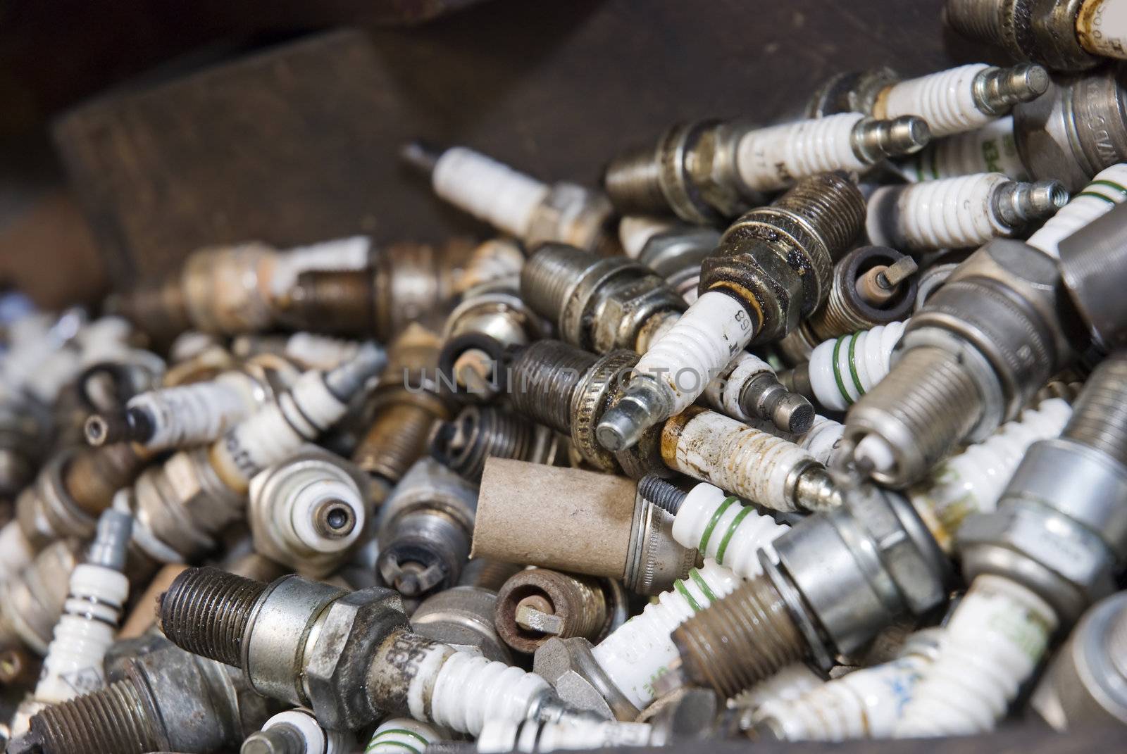 Details shot of a pile of old spark plugs.