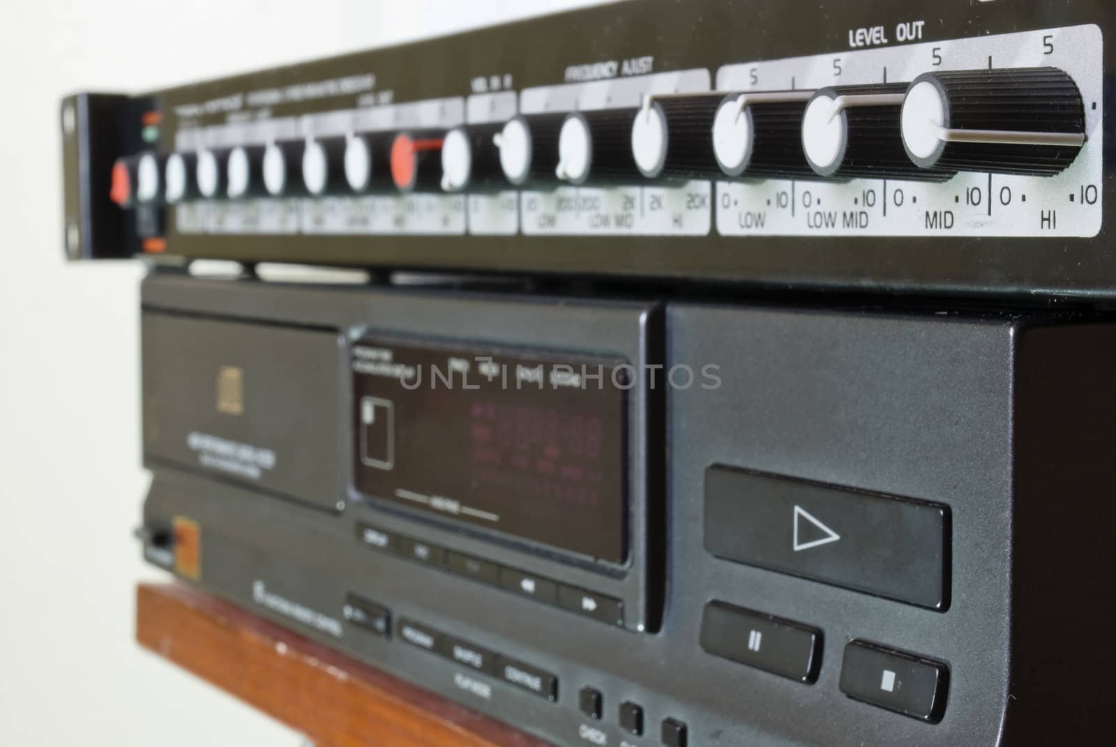 Perpendicular shot of a crossover on top of a CD player.