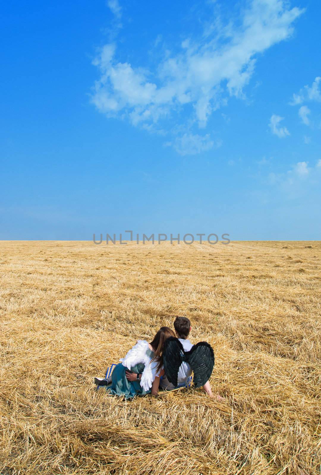 Young happy couple on the field. Shoot on the nature.