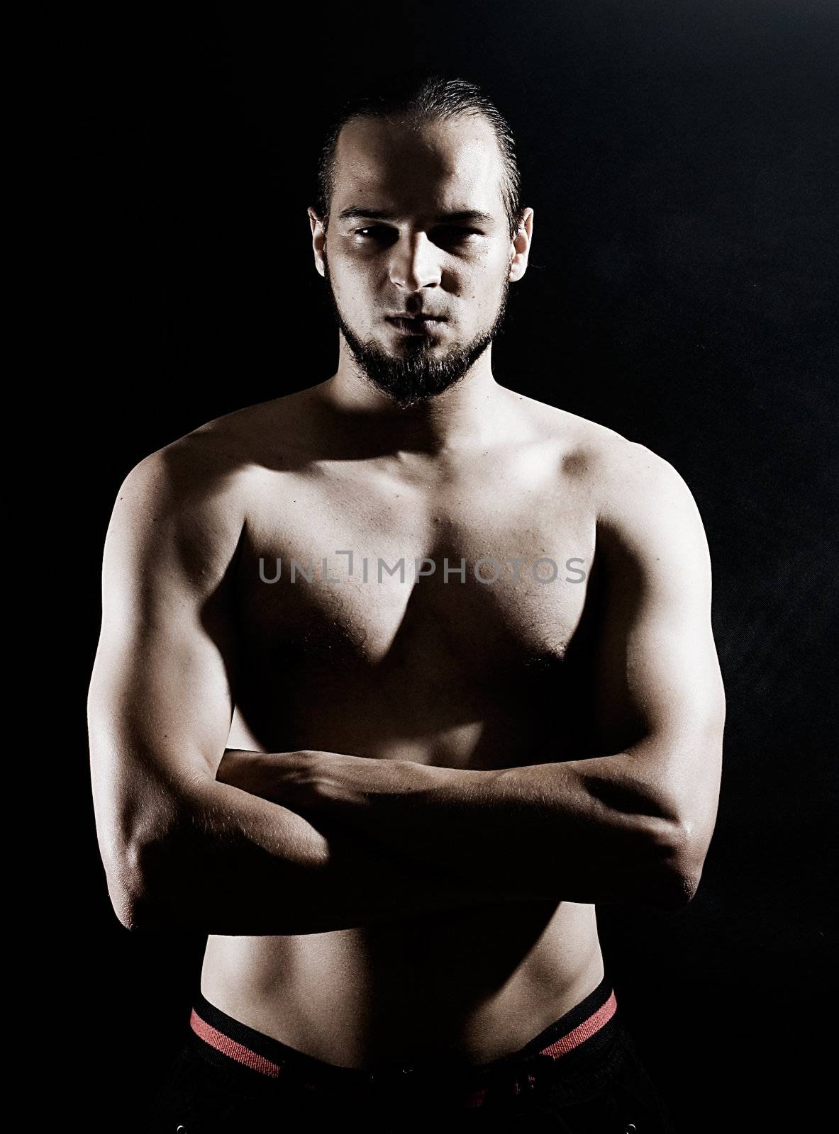 Muscular man over black background