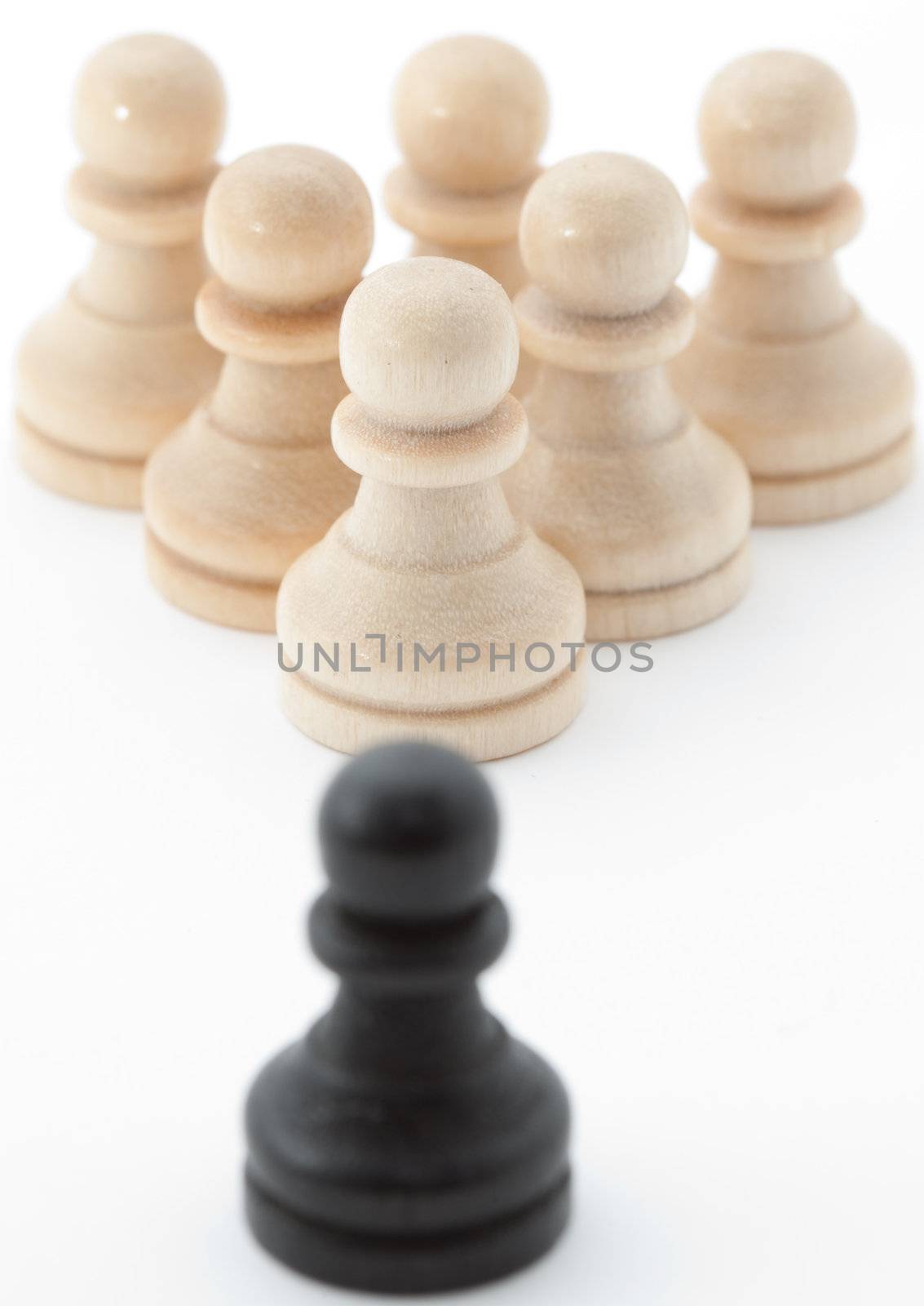 Pawns in two different colors. Symbolizing a community and an outsider