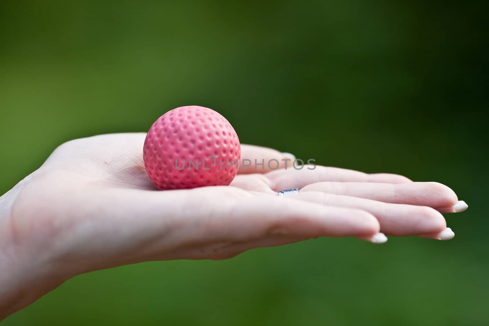 Woman with nice fingertips holding a golfball