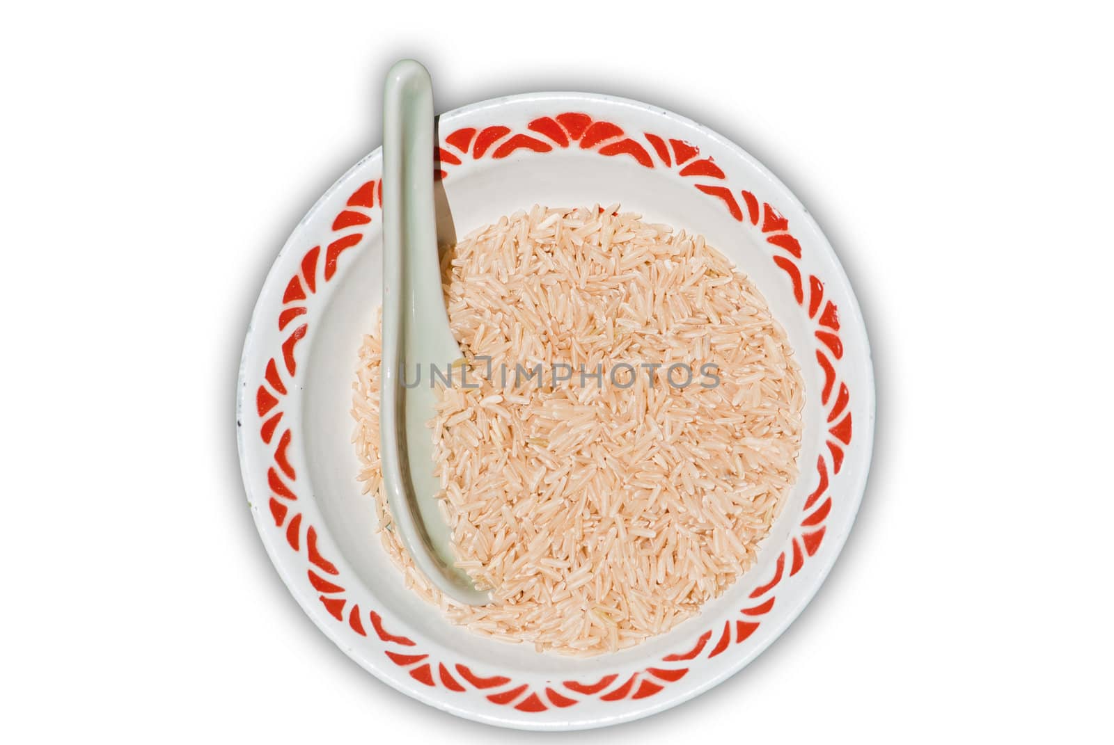 Close up shot of brown rice in a bowl with spoon, isolated