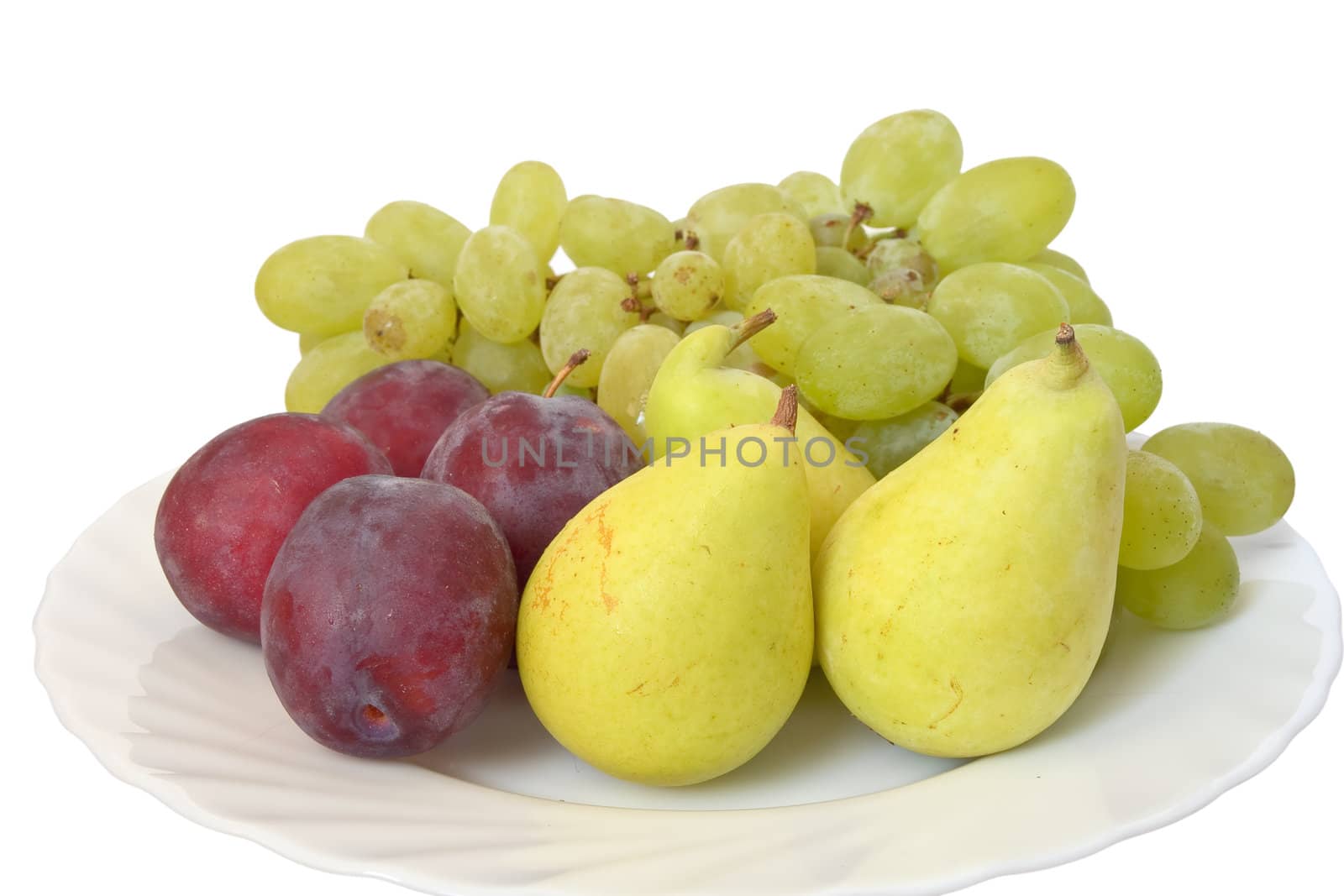 plate with plums, grapes and pears isolated on white background
