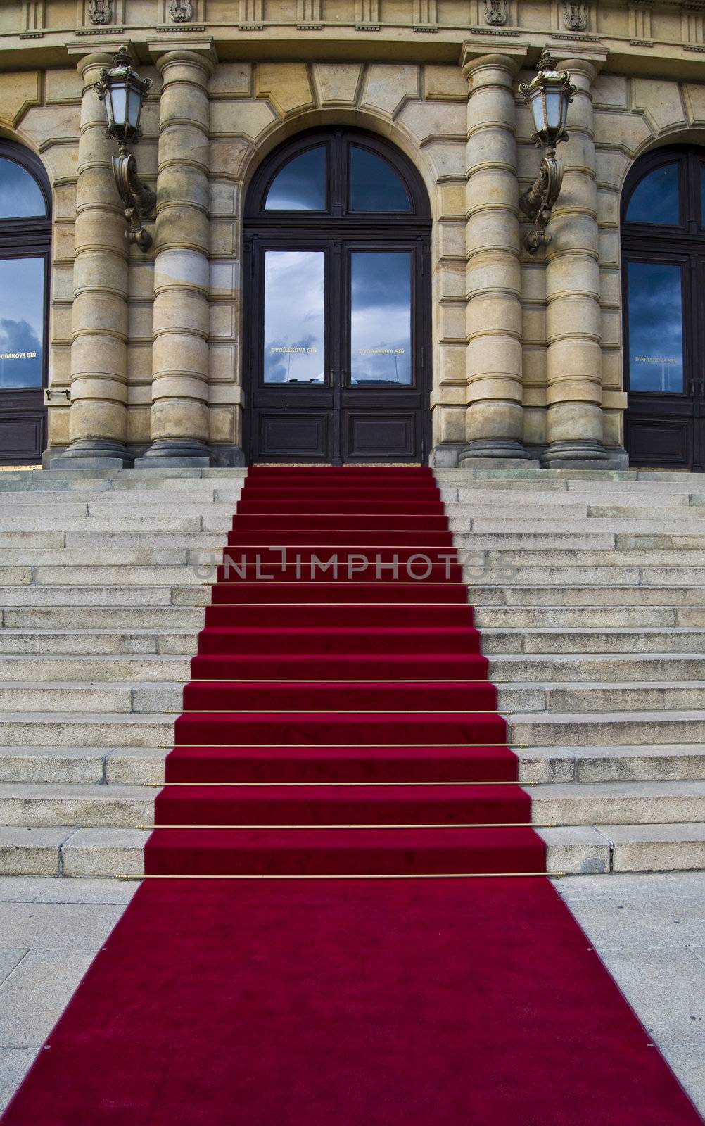 beautiful red carpet leading up old steps 