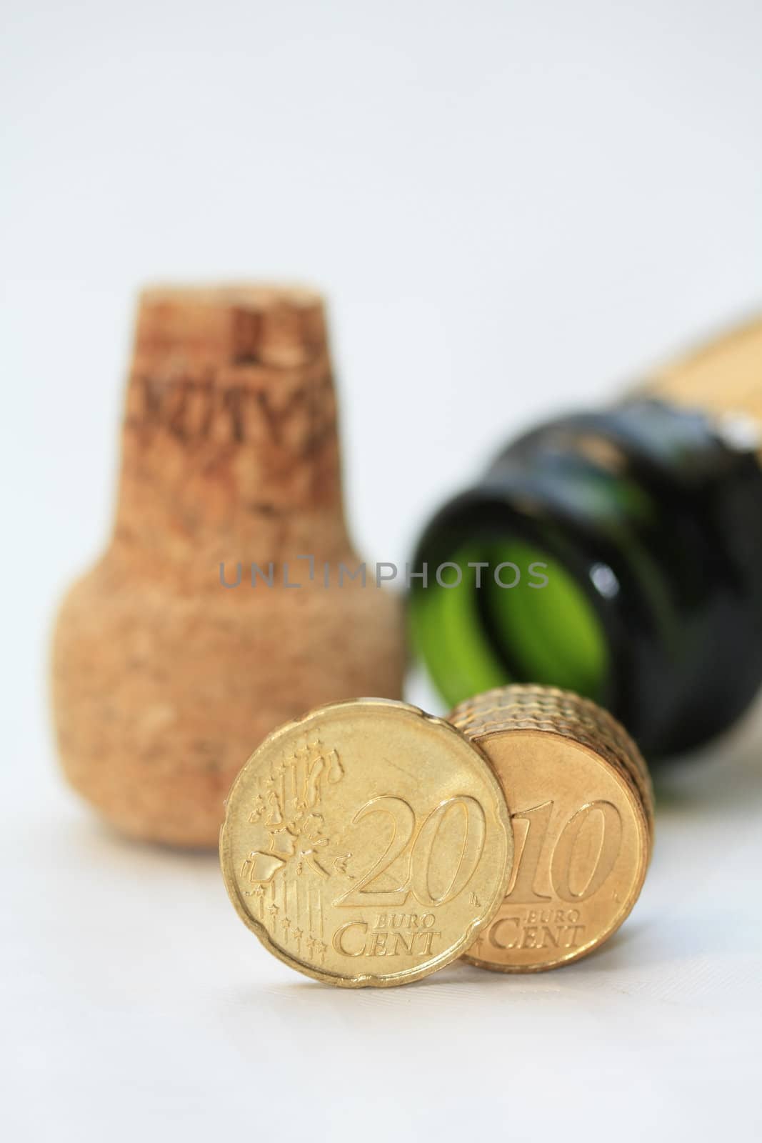 Two euro coins in front of a champagne bottle, perfect new years greeting