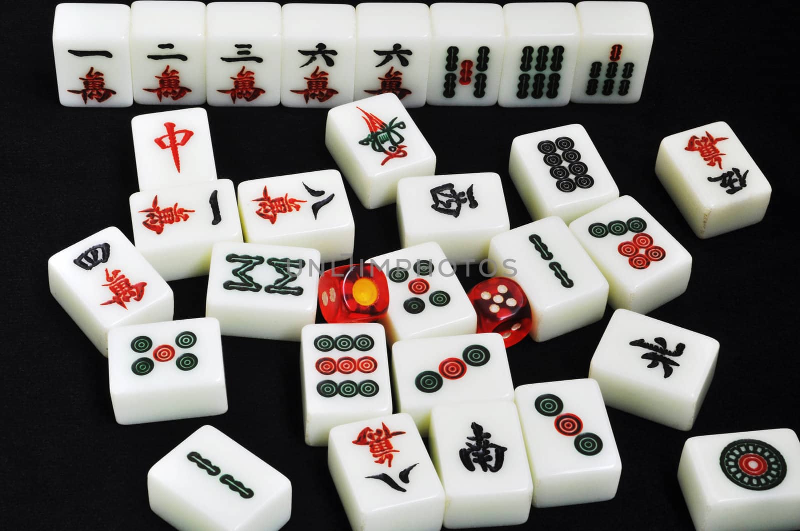 Chinese mahjong tiles and dices on a black background