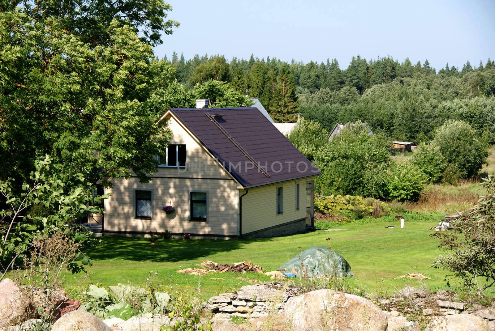 Modern apartment house on a background of a green grass and trees