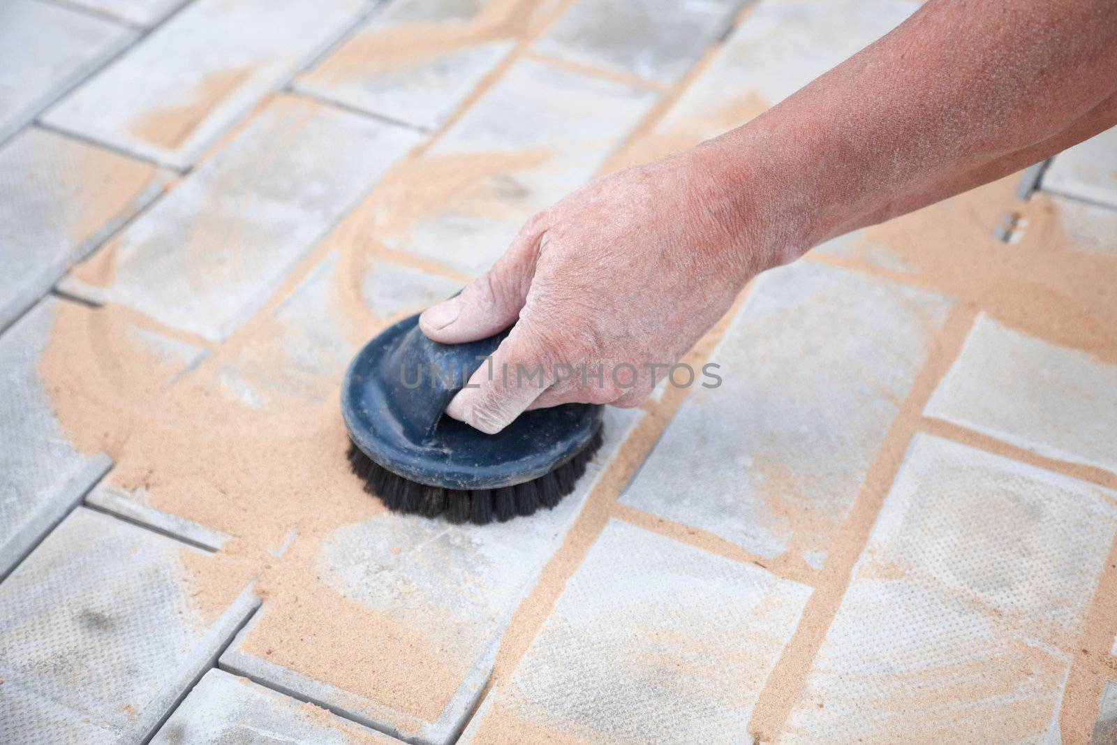 Installation of a brick platform - smoothing-out with sand