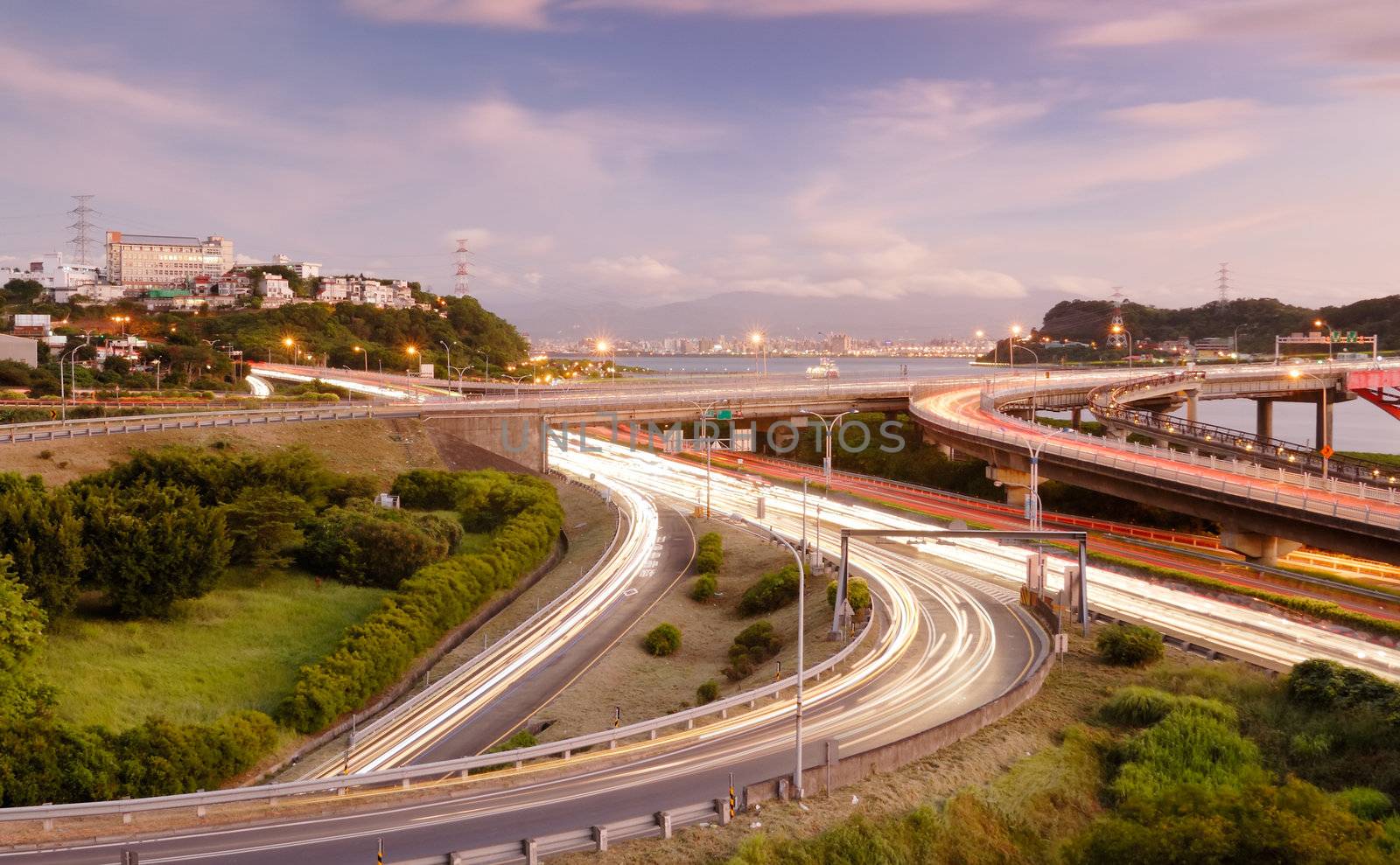 It is a cityscape of interchange with cars light.