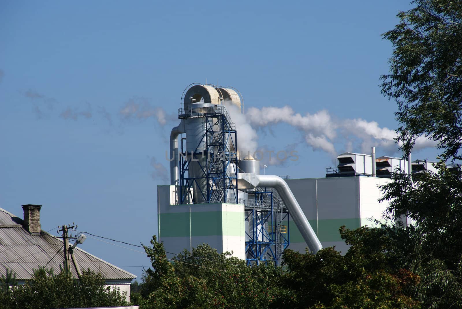 Pipes of a factory on a background of the blue sky