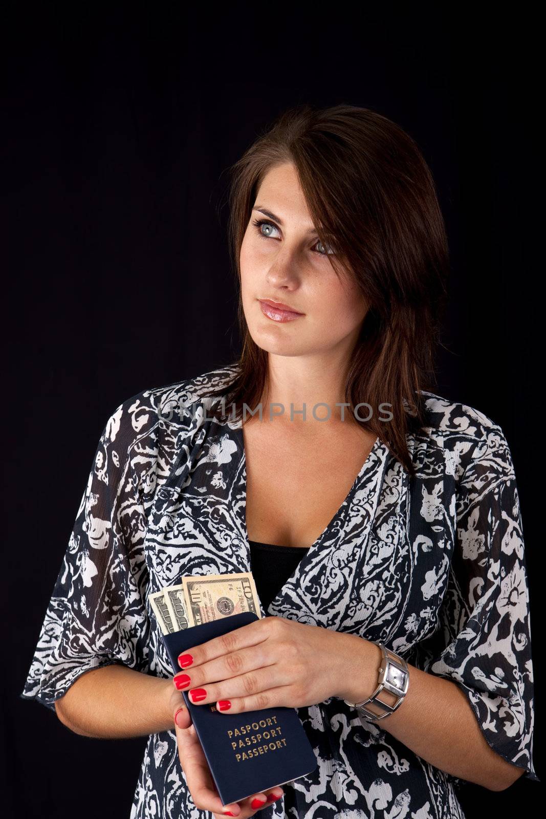 World Traveller with money in her passport thinking about her trip