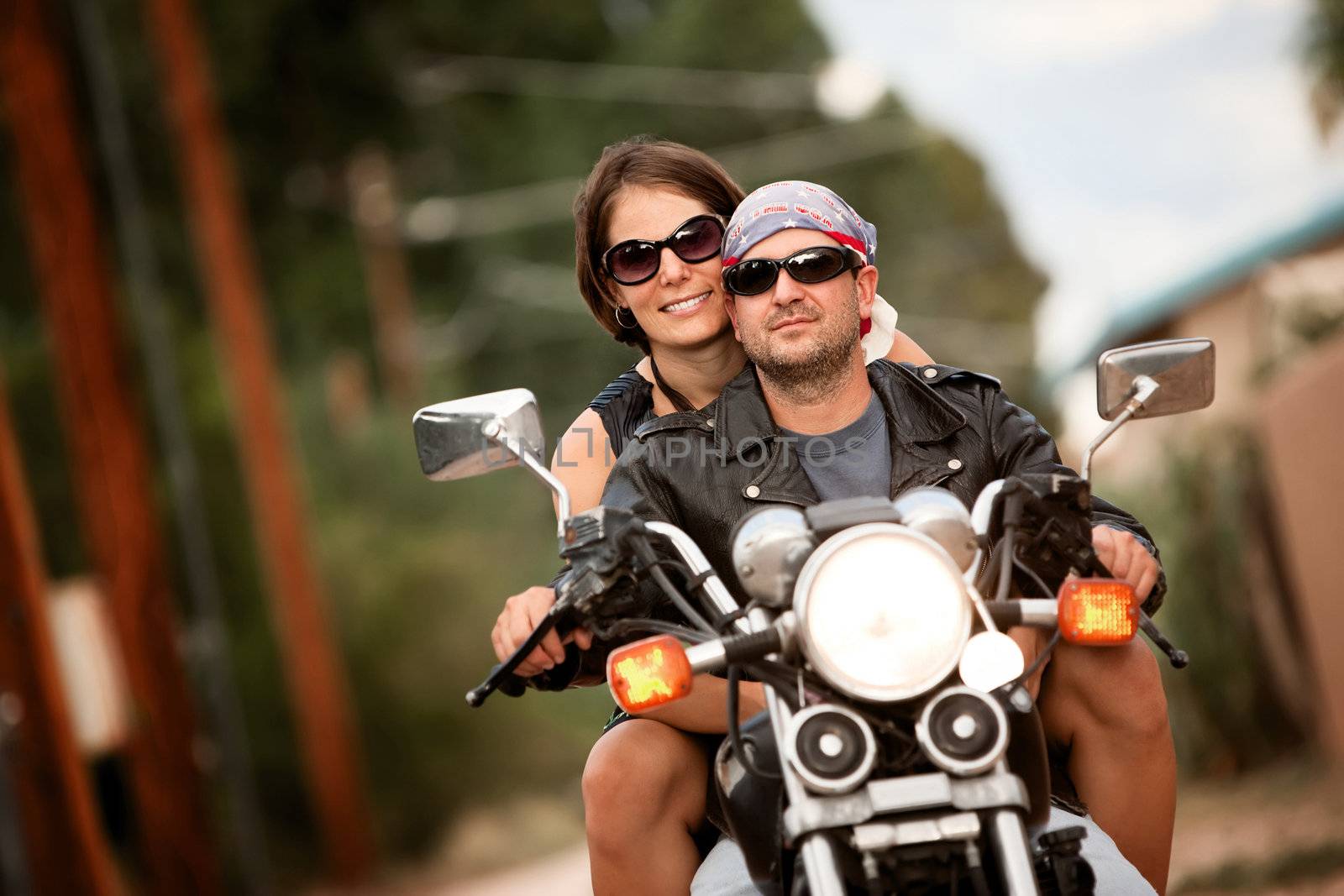 Man and Woman riding on vintage motorcyle