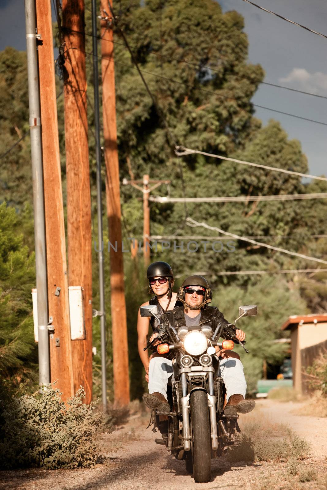 Man and Woman on Motorcycle by Creatista