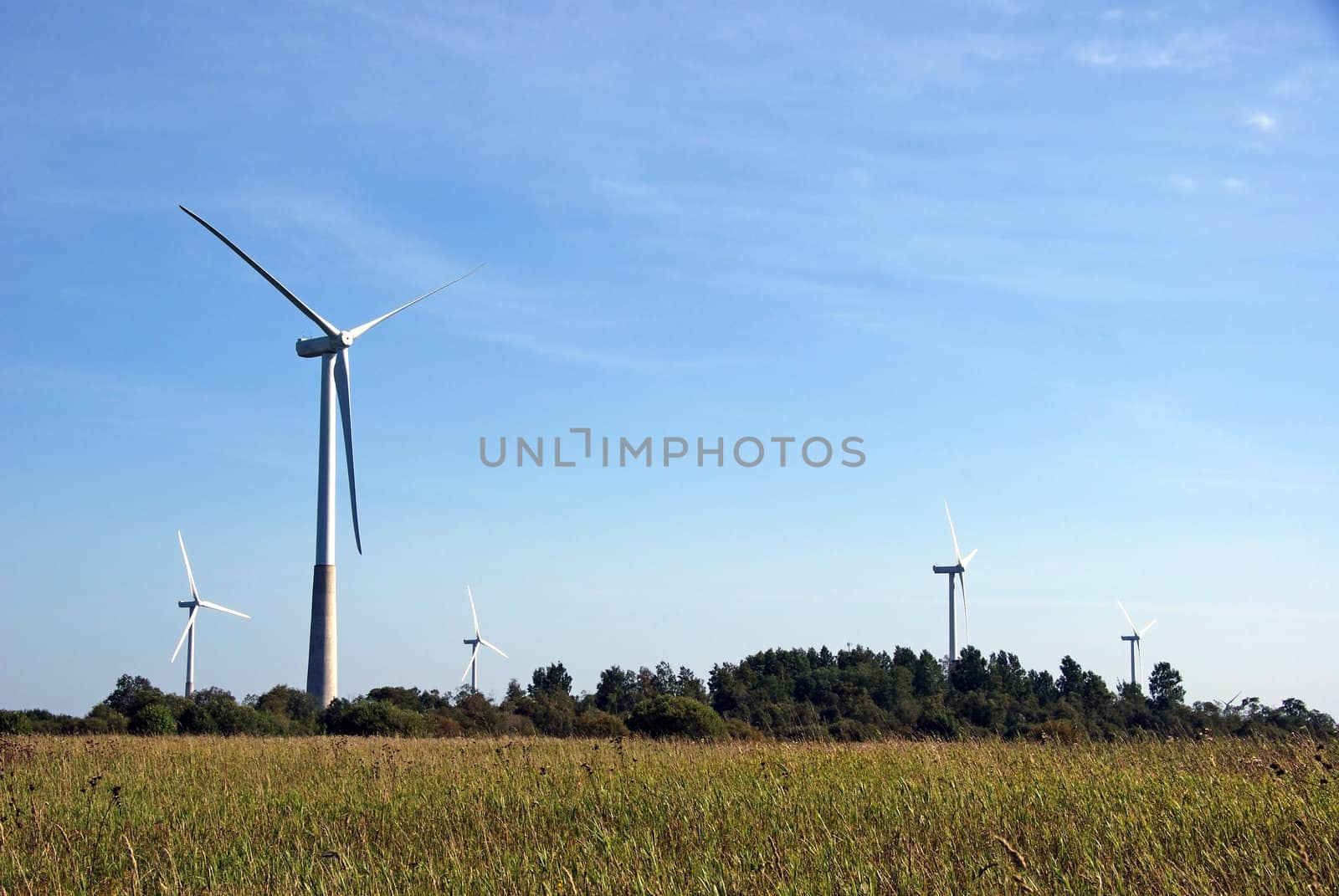 The wind generator on a background of the nature and the sky