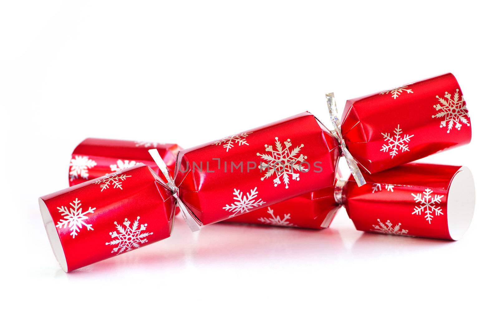 Two red Christmas crackers isolated on white