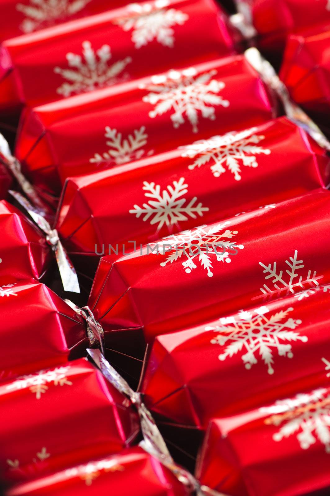 Closeup of many red Christmas crackers in a row