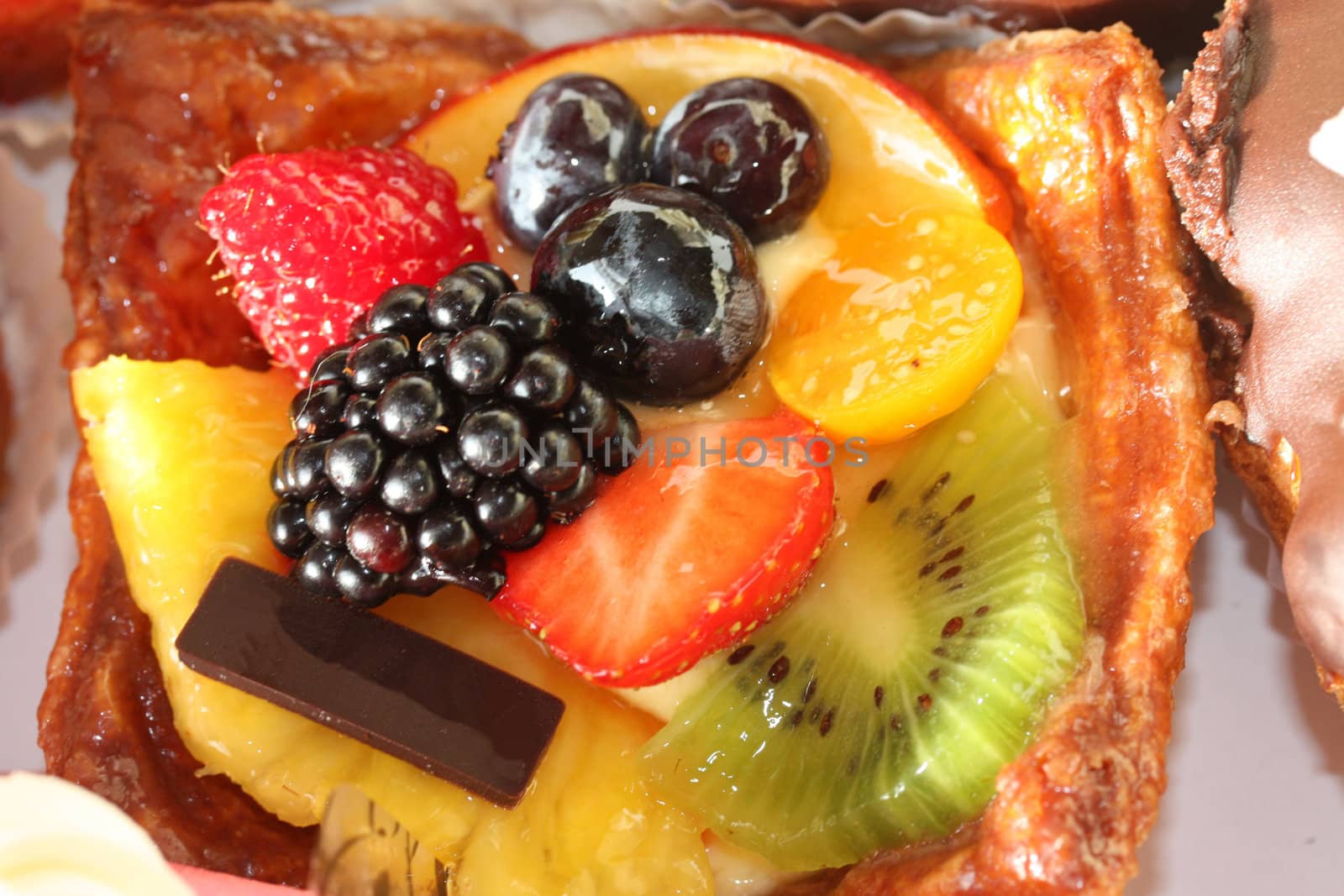 Fruit pastry with fresh strawberry, grapes, mango and kiwi