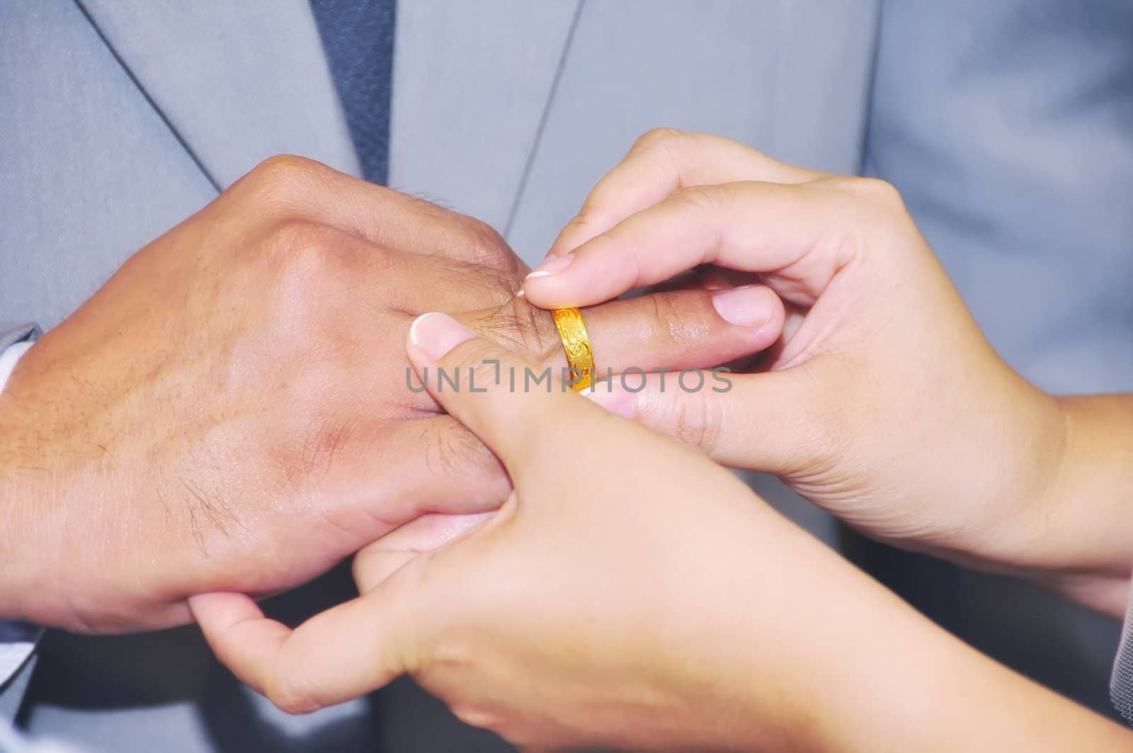 Bride giving her ring to groom during a wedding ceeremony