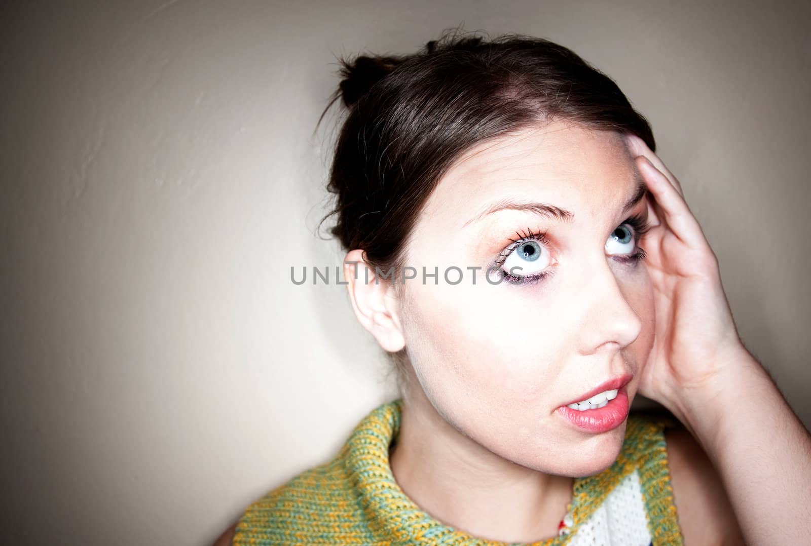 Cute young perplexed girl captured in a circlular spotlight