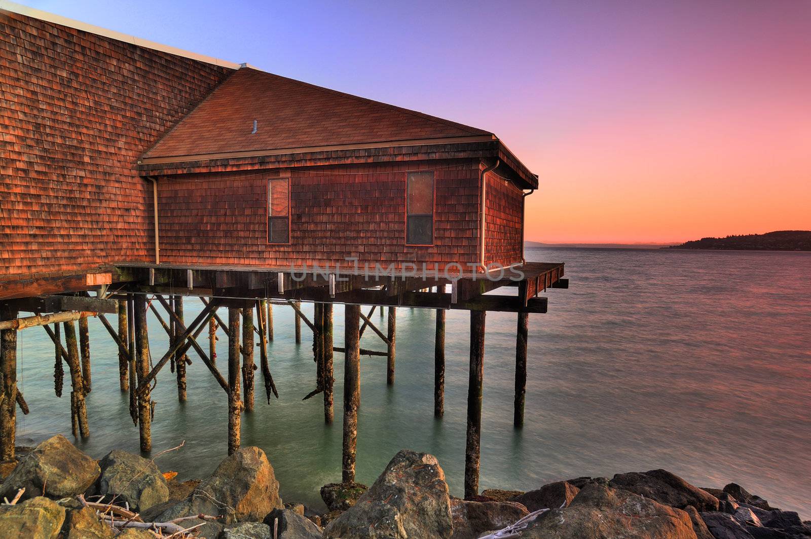 Beautiful old tavern over waterfront at sunrise HDR image