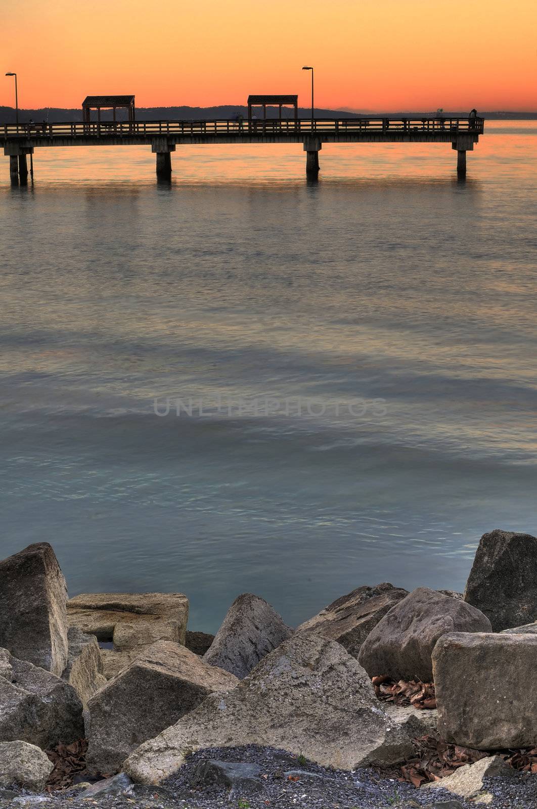 Fishing pier at sunset by neelsky