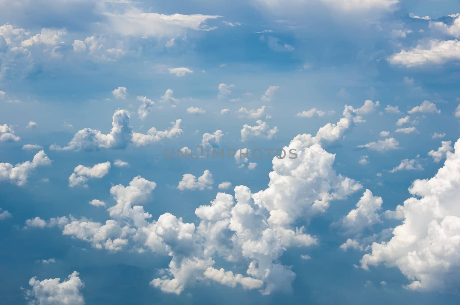 Fluffy clouds shot from airplane window