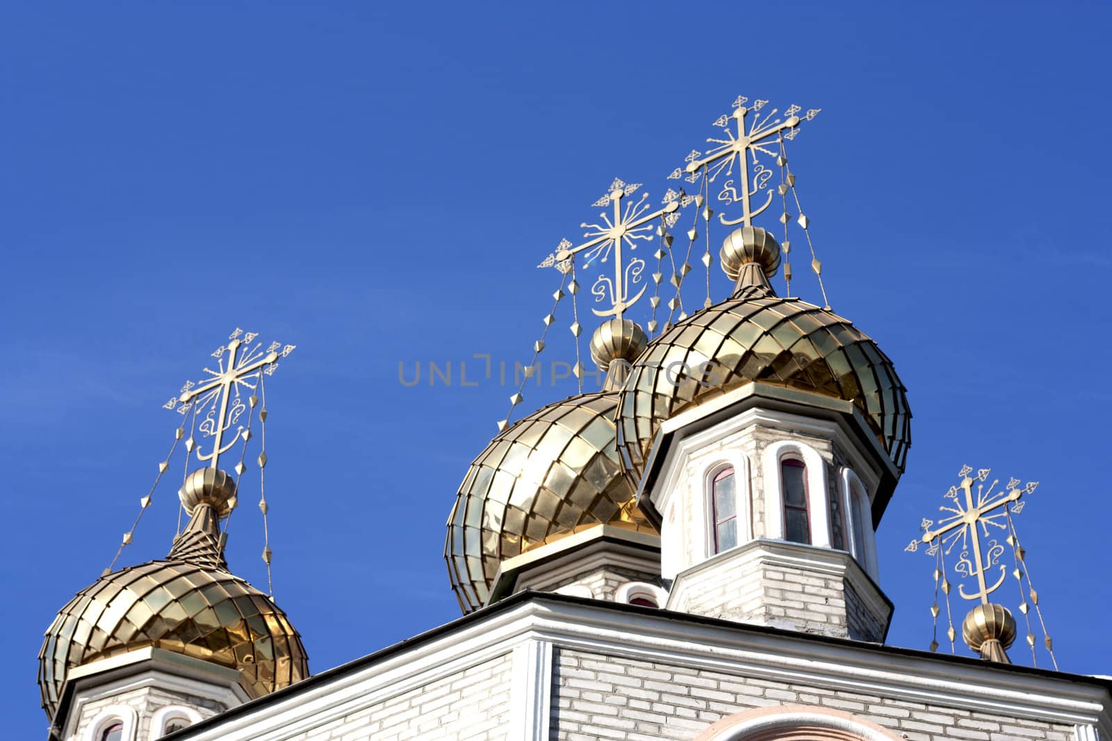 Golden dome of the Orthodox church with blue sky background, Russia. 