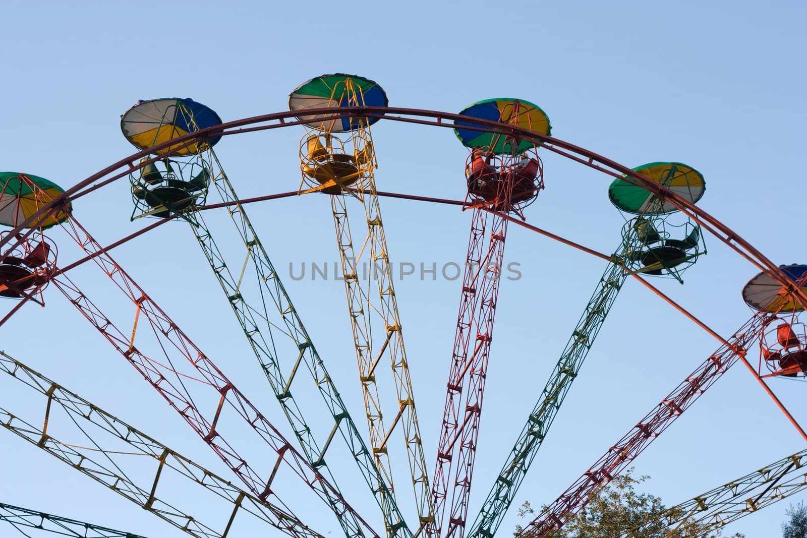 Ferris wheel on the blue sky background  by schankz