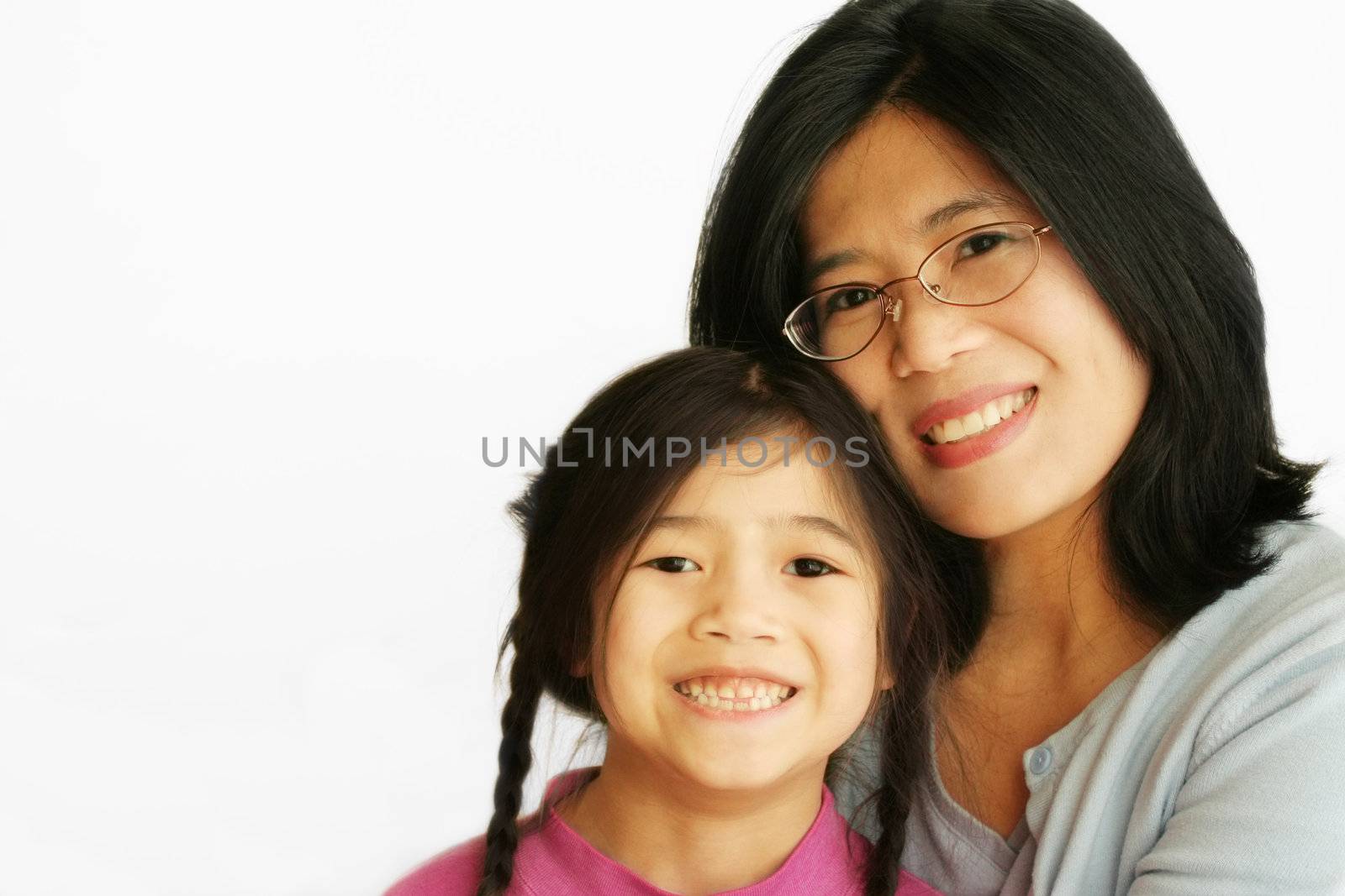 Asian mother sitting with her young daughter