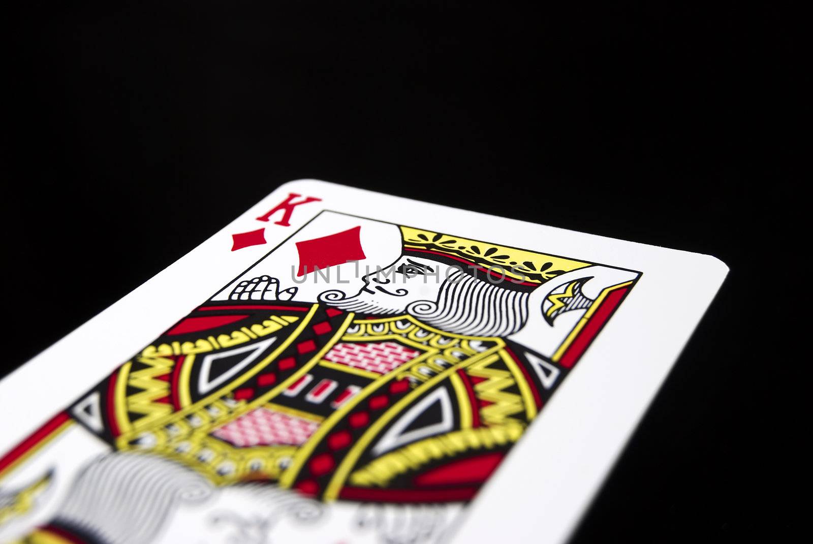 King of Diamonds against black background