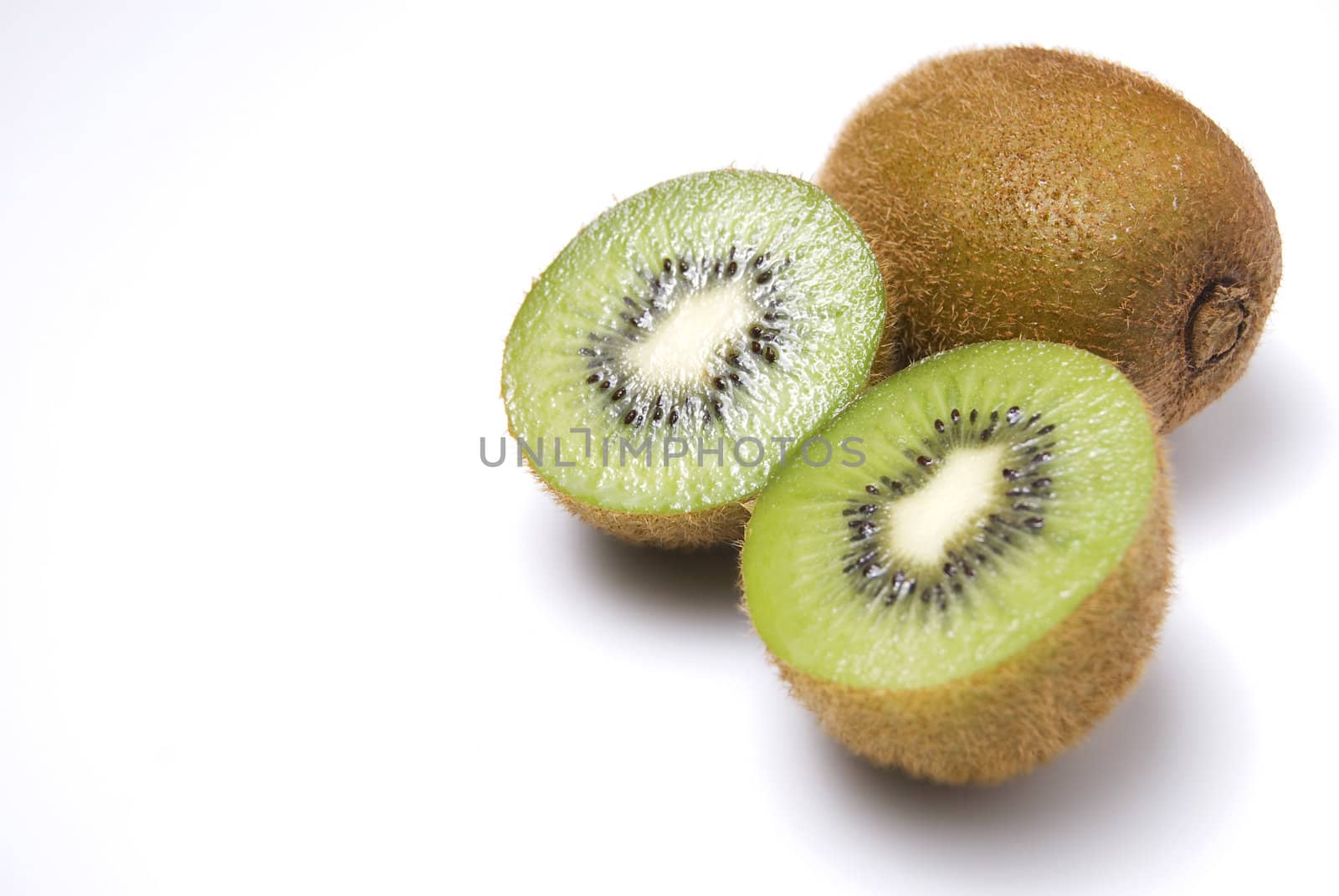 Whole and sliced kiwi fruit on white background