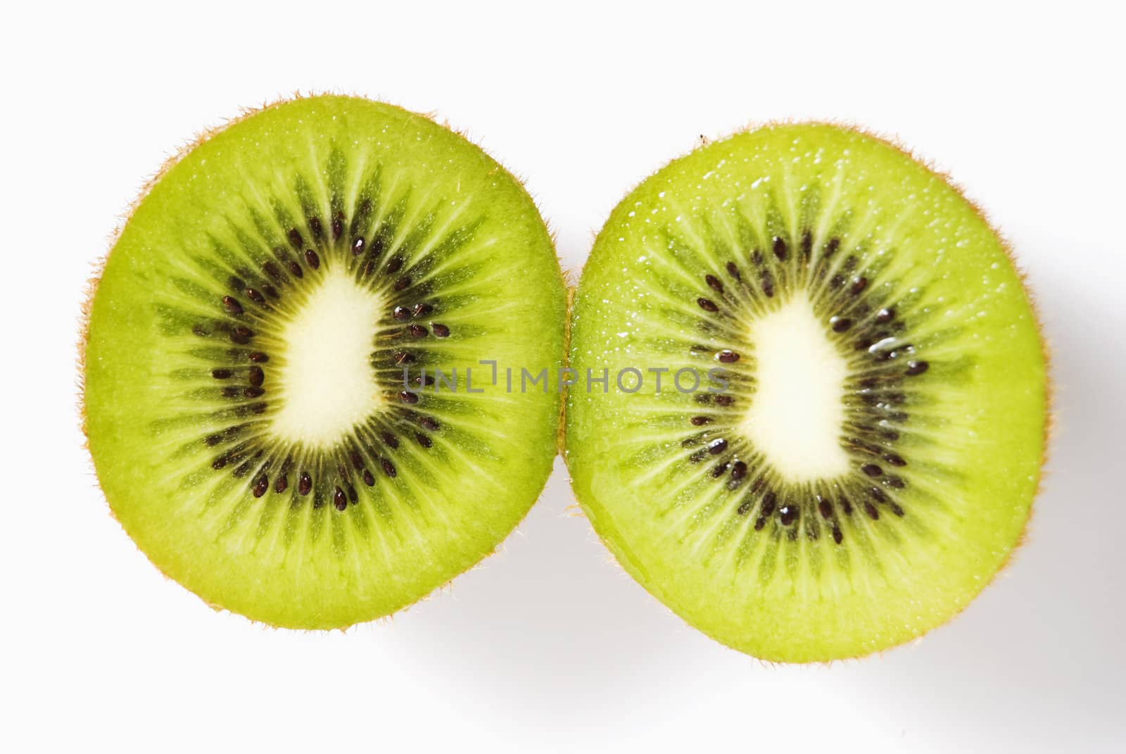 Cross-section of sliced kiwi fruit on white background