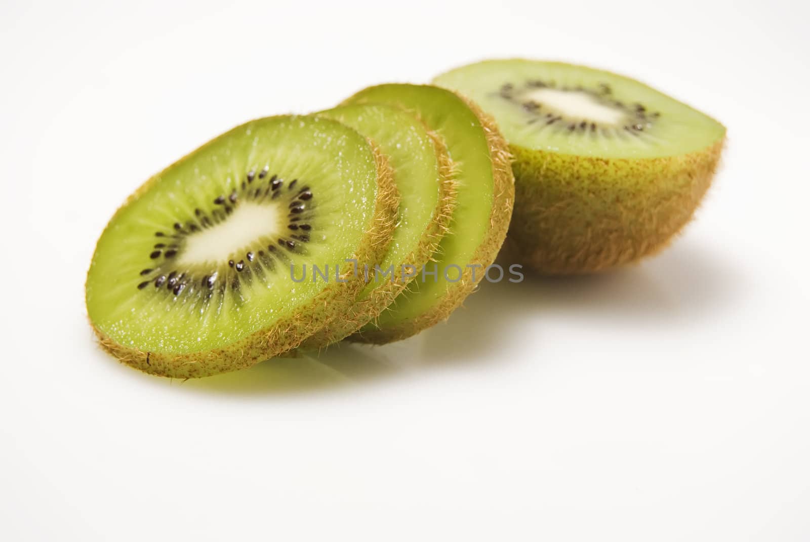 Slices of kiwi fruit on white background