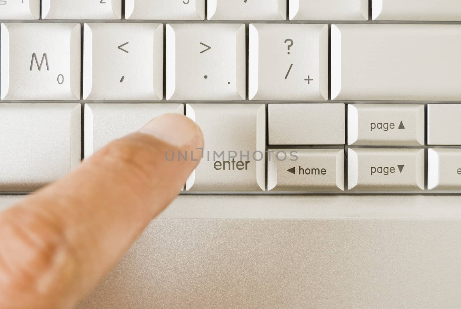 Forefinger about to hit "enter" on computer keyboard