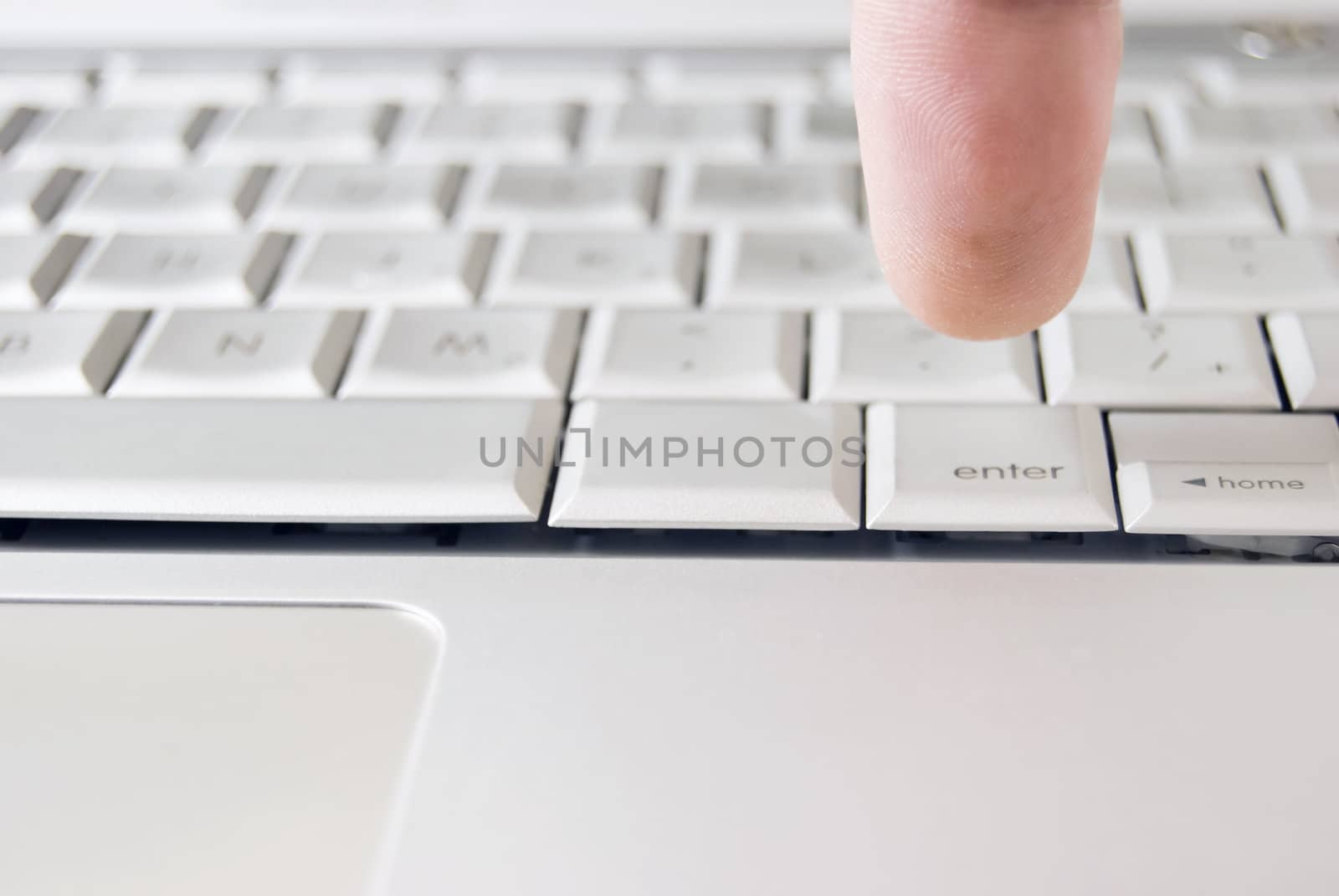 Finger of adult on computer keyboard