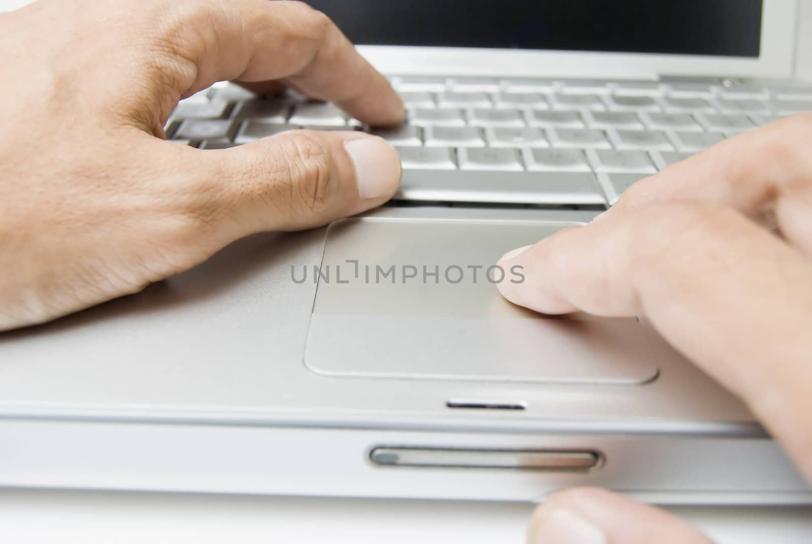 Male's hands on computer keyboard