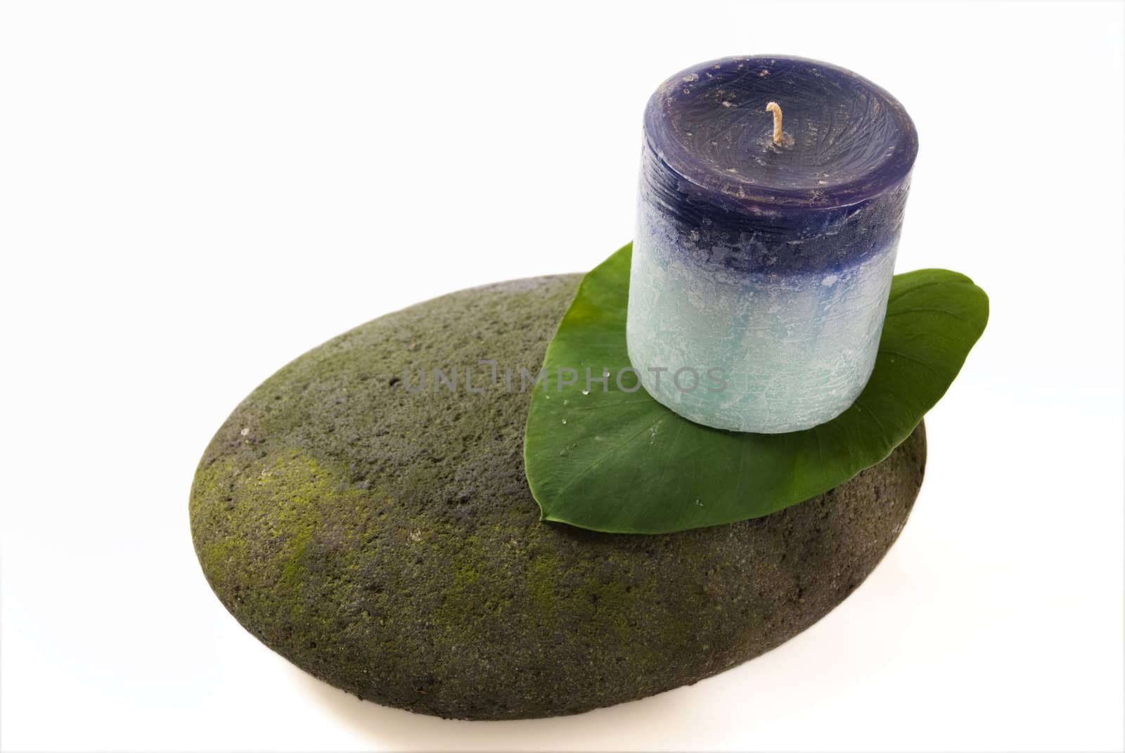 Still life of rock, leaf, and candle