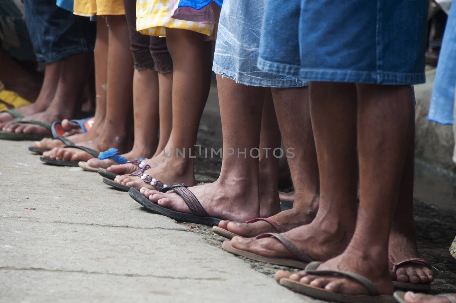 A line of feet of spectators in a rural area