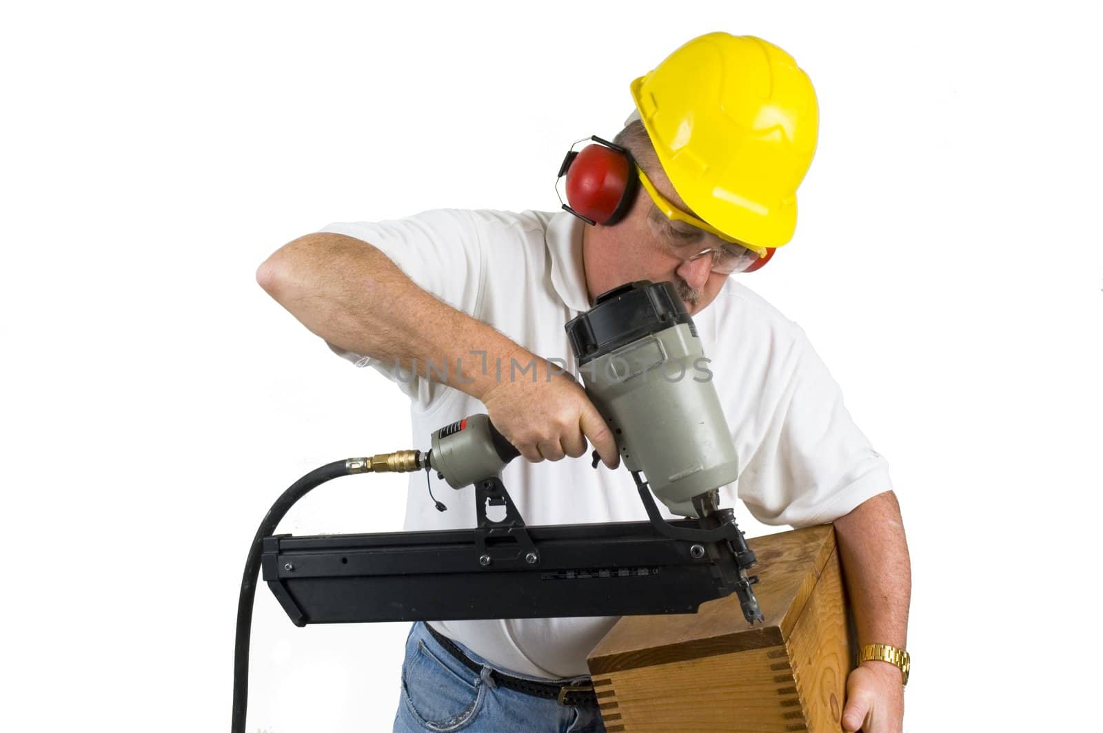 Carpenter using nail gun to repair box