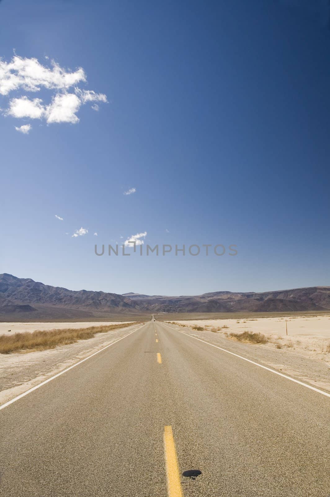 Straight road across the desert in Death Valley, California