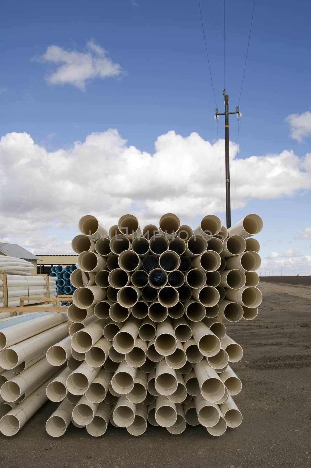 Agricultural irrigation piping stacked on farm